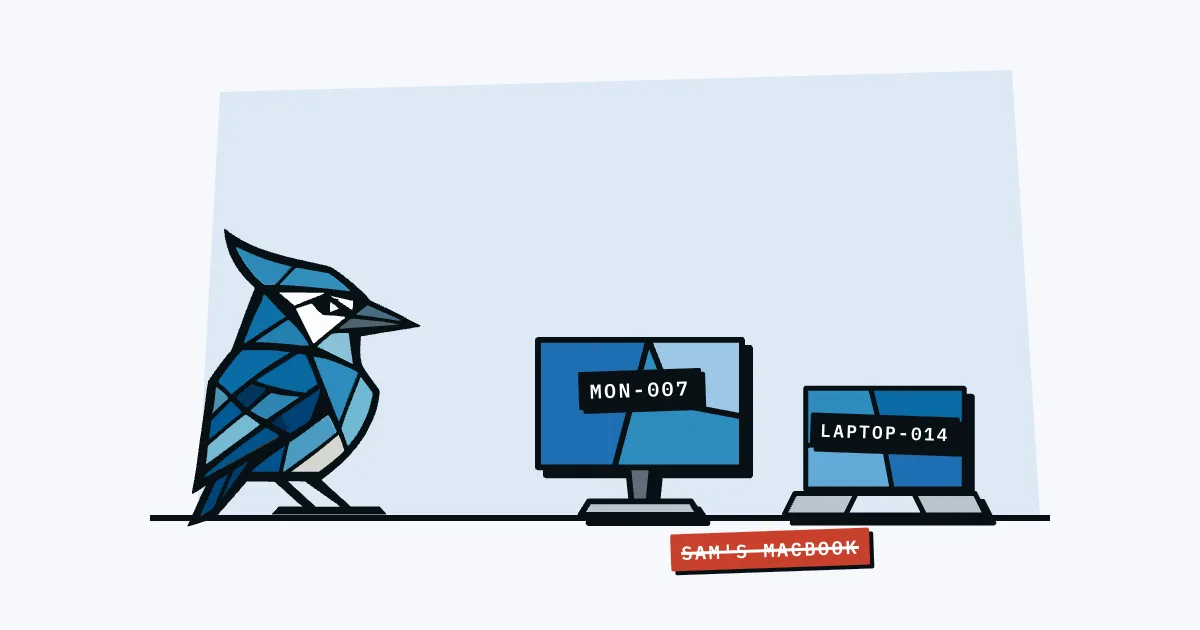 Jay the blue jay facing a monitor labelled MON-007 and a laptop labelled LAPTOP-014, with a crossed-out SAM'S MACBOOK tape below