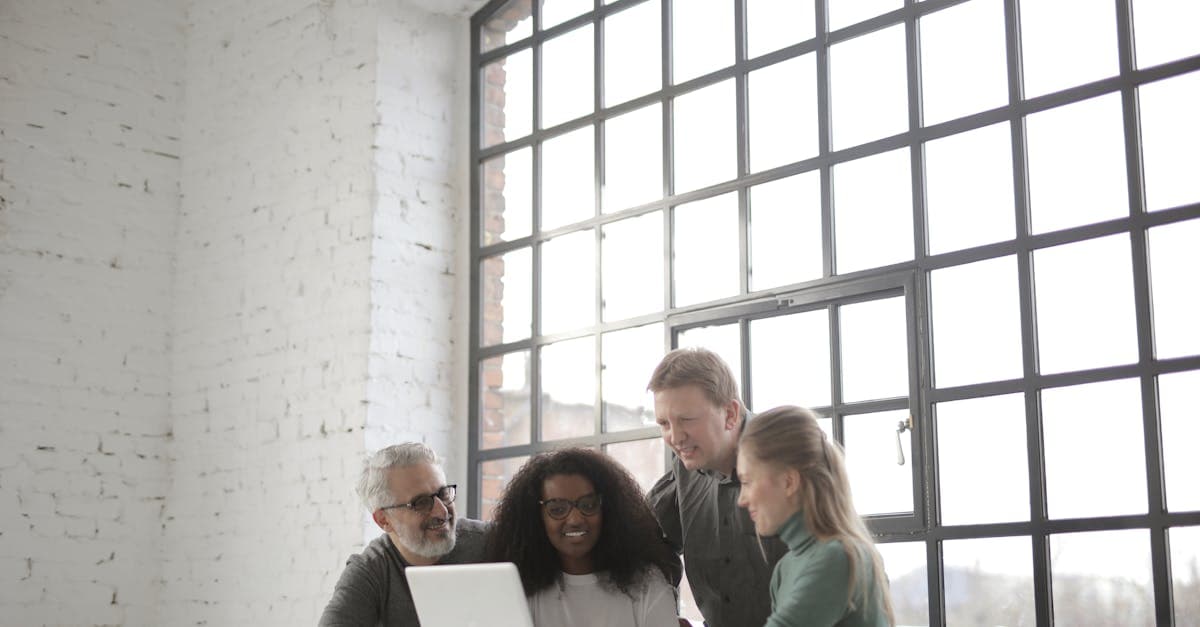 Small team working together with laptops in an office